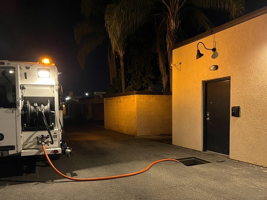 Night jetting call lit by an amber truck beacon — grease trap cleaning in Fullerton, CA